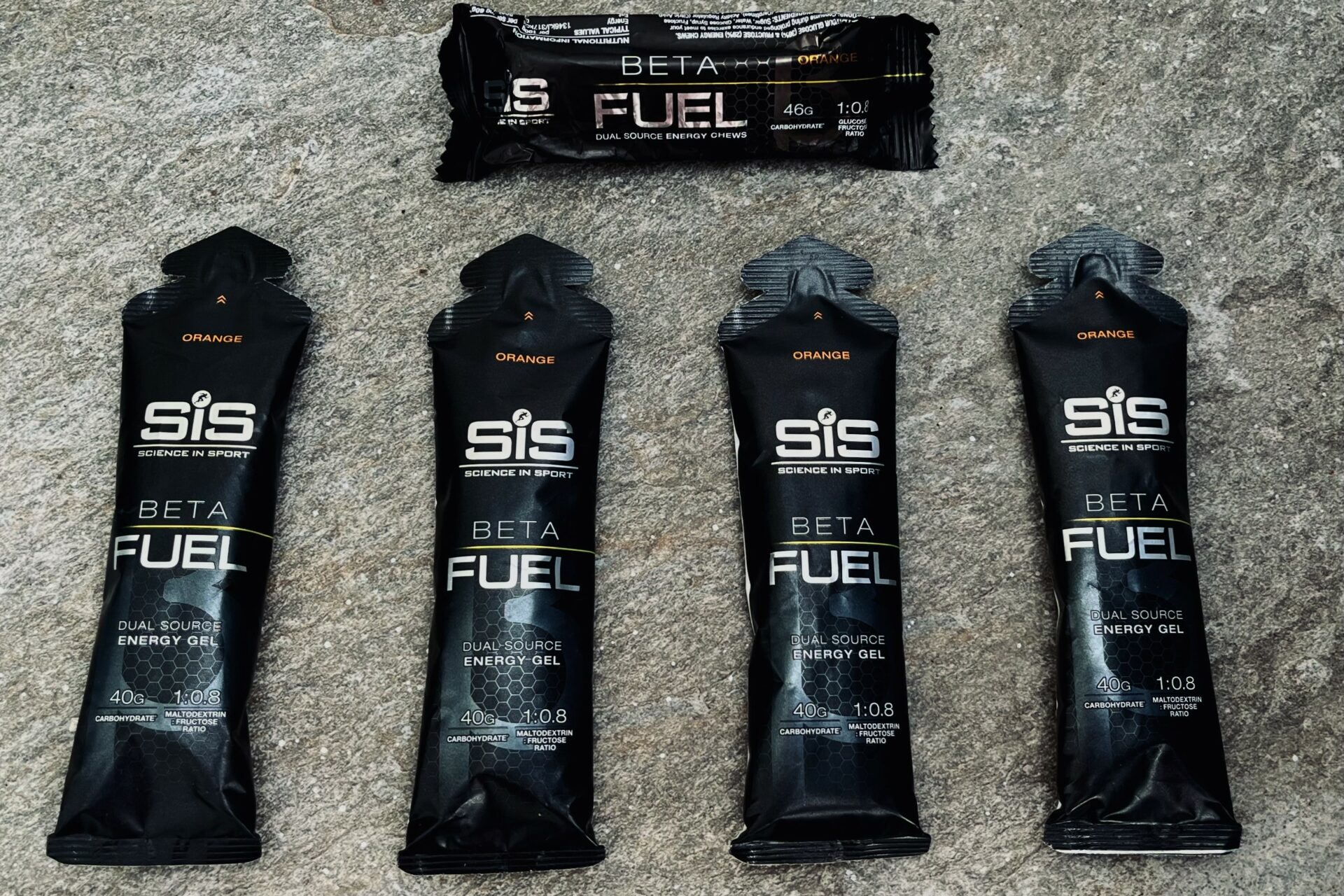 On a grey floor science in sport beta fuel gels are laying ready to be consumed during a bike ride.